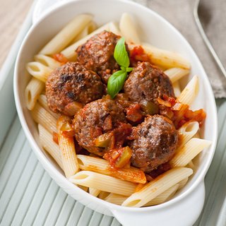 Meatballs in tomato sauce, served with penne pasta