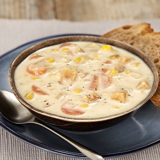 A bowl of thick, cream-coloured soup with chunks of vegetables