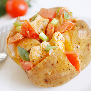 Jacket potato, with a creamy chicken and tomato filling.