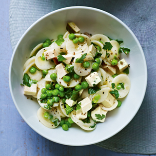 A portion of pasta with chicken and peas