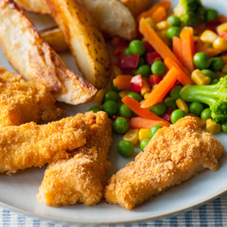 Crispy breaded fish goujons served with baked sweet potato wedges and mixed veg