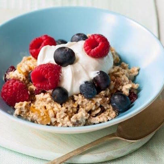 Oats topped with yoghurt, raspberries and blackberries