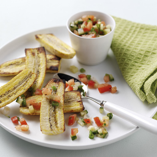 Grilled plantains, served with a salsa made of finely chopped tomatoes, cucumber and spring onions.
