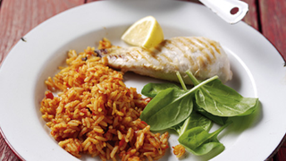 Rice cooked in a rich, spicy tomato sauce, served with grilled fish and a slice of lemon