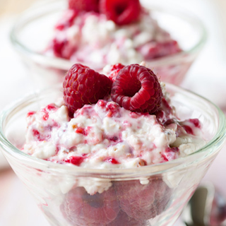 Chilled yoghurt drizzled with raspberry juice and mixed with fresh raspberries