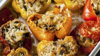 Baked tomatoes and peppers, stuffed with a rice mixture and topped with melted cheese.