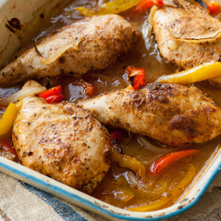 Chicken breasts roasted in stock with red and yellow peppers