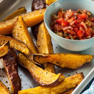 Wedges of roasted sweet potato served with a tomato and onion salsa