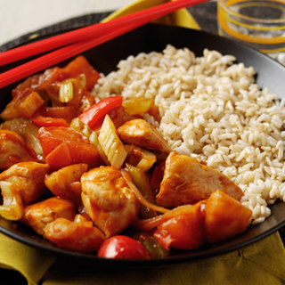 Chunks of chicken, celery and pepper in a sweet and sour sauce, served with rice