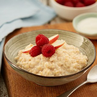 Porridge topped with raspberries and sliced apple