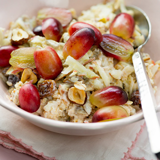 Toasted oats topped with yoghurt, halved grapes and grated apple