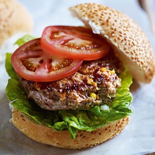 Grilled turkey burger served in a bun with lettuce and tomato