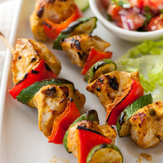 Barbecued chunks of turkey, pepper and courgette on a skewer