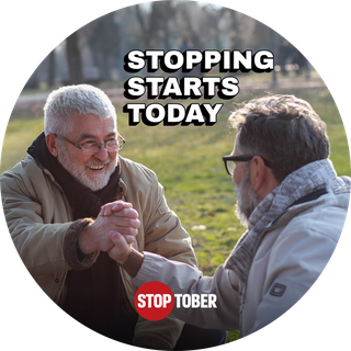 Two men in a park giving a high five, with the slogan "Stopping Starts today" alongside the Stoptober logo.