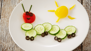 "Caterpillar" made from slices of cucumber, red pepper and yellow pepper