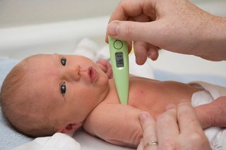 Taking a baby's temperature with a digital thermometer