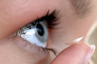 Close-up of a contact lens being put into an eye