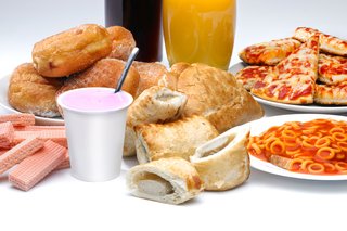 A collection of processed food, including sausage roll, pizza and spaghetti hoops.