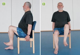 A seated man raising his left foot about 10 cm off the floor, with his right foot remaining on the floorht